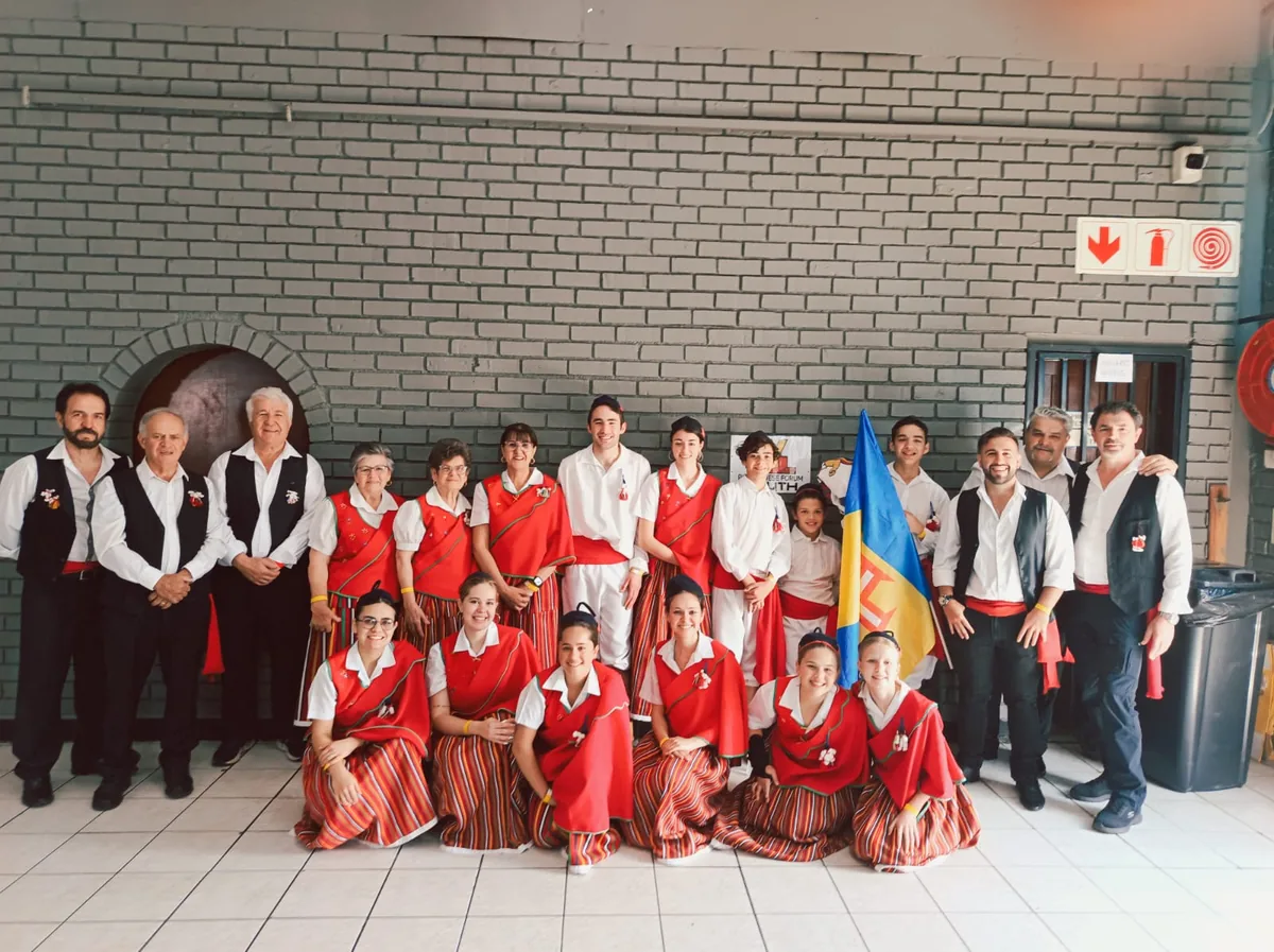 The Rancho Folclórico da Casa Social da Madeira de Pretória in traditional Madeiran dress with the Madeira flag